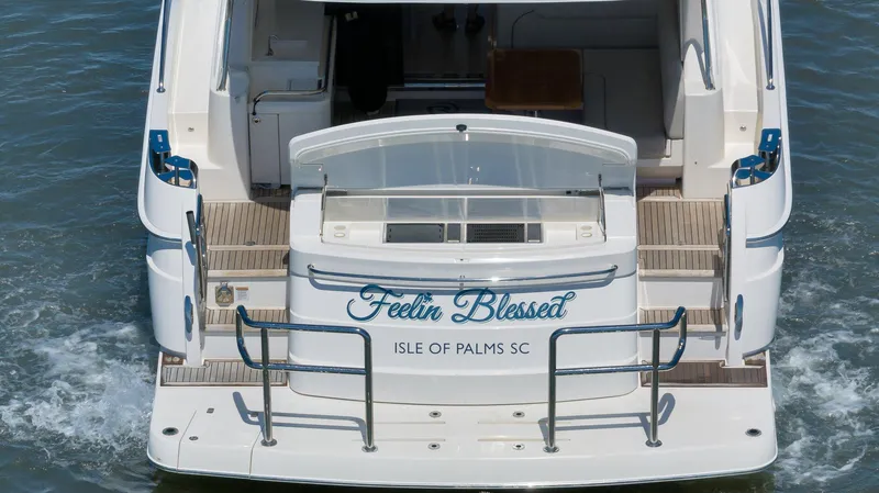 Slide: The Image of Riviera 4800 Sport Yacht 2020, rear view, named "Feelin Blessed," docked at Isle of Palms, SC. - 22