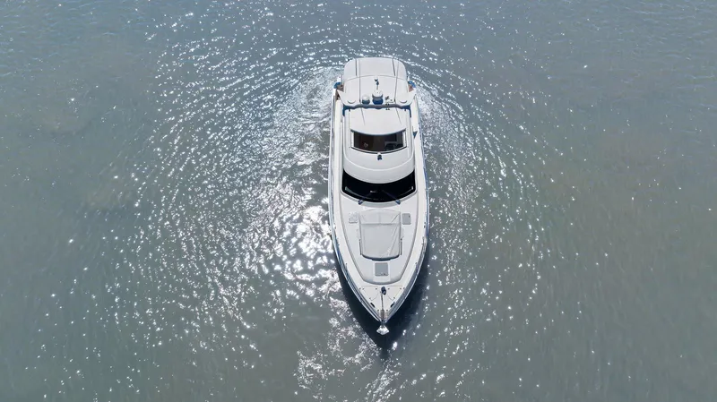 Slide: The Image of 2020 Riviera 4800 Sport Yacht cruising on calm waters, aerial view. - 23