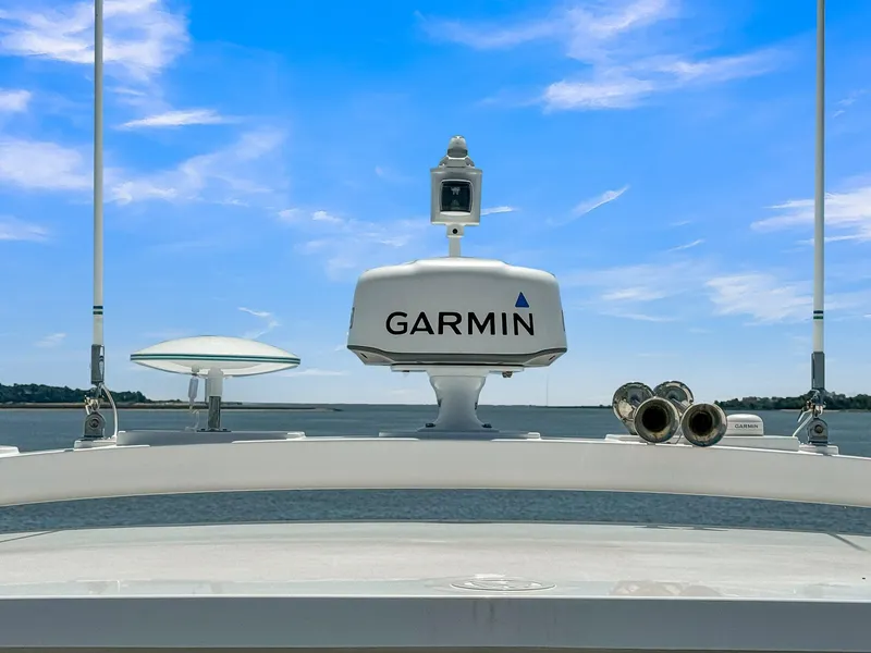 Slide: The Image of Riviera 4800 Sport Yacht 2020 with Garmin radar against blue sky. - 26