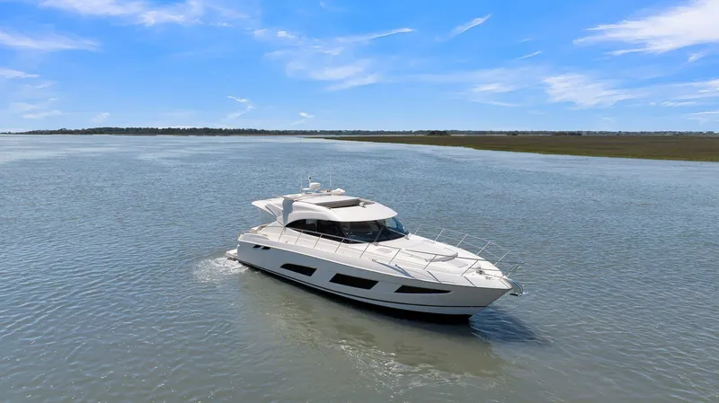 Slide: The Image of 2020 Riviera 4800 Sport Yacht cruising on a calm, sunny day. - 3