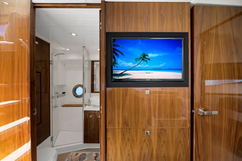 Slide: The Image of Luxurious 2020 Riviera 4800 Sport Yacht interior with wood paneling and modern bathroom. - 42