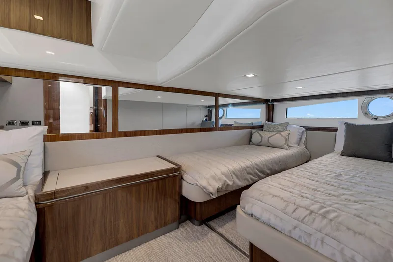 Slide: The Image of 2020 Riviera 4800 Sport Yacht interior with twin beds and modern design. - 47