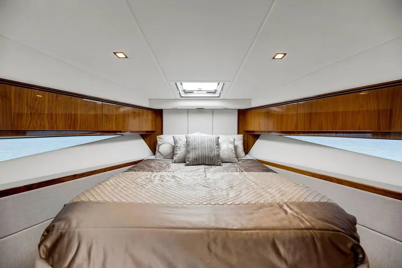 Slide: The Image of Luxurious bedroom interior of 2020 Riviera 4800 Sport Yacht with elegant wood finishes. - 48