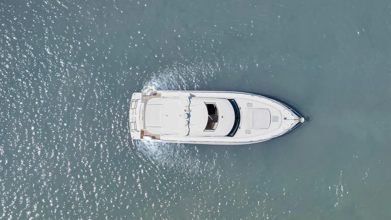 Slide: The Image of Aerial view of 2020 Riviera 4800 Sport Yacht cruising on open water. - 6
