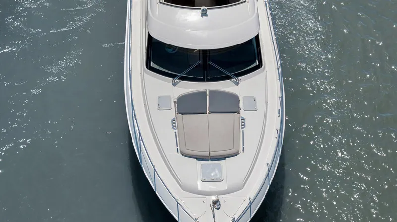 Slide: The Image of 2020 Riviera 4800 Sport Yacht cruising on calm waters, aerial view. - 9
