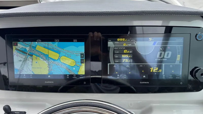 Slide: The Image of Dashboard of 2024 Regal 26 XO boat with dual Garmin displays showing navigation and performance data. - 13