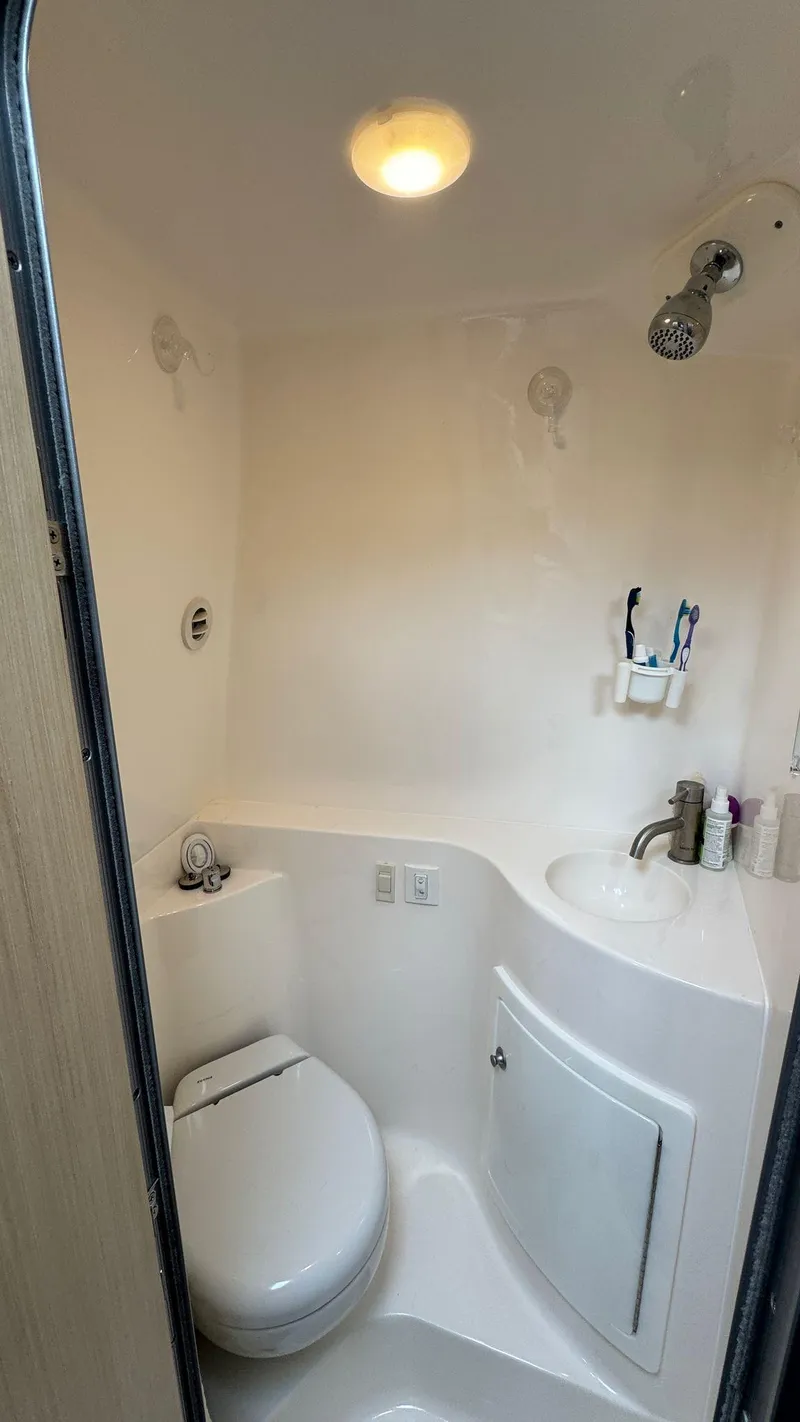 Slide: The Image of 2024 Regal 26 XO boat bathroom with modern fixtures and compact design. - 18