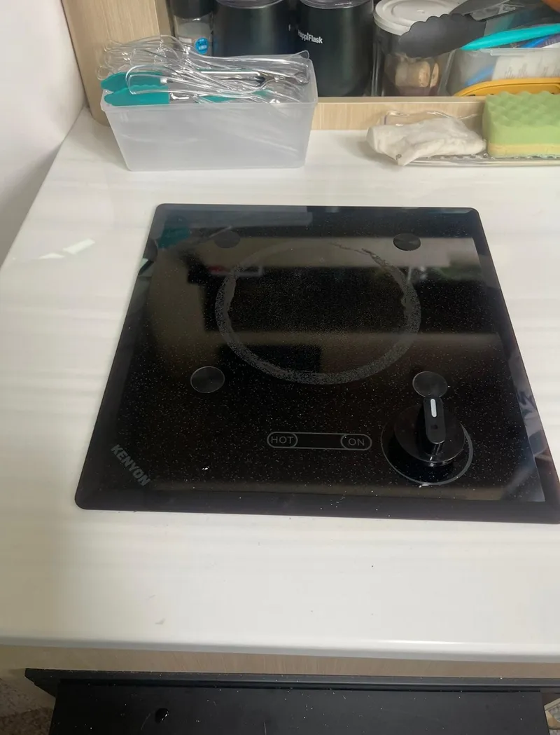 Slide: The Image of 2024 Regal 26 XO boat kitchen with Kenyon electric cooktop. - 23