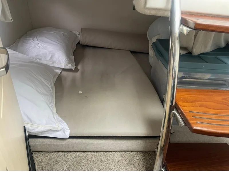 Slide: The Image of 2024 Regal 26 XO cabin interior with bed and wooden steps. - 24