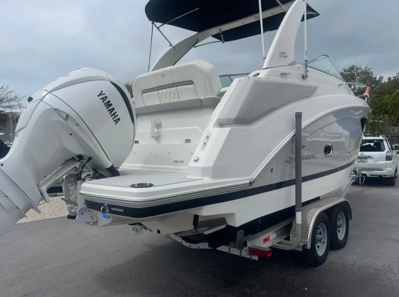 Slide: The Image of 2024 Regal 26 XO boat with Yamaha outboard engine on a trailer. - 3