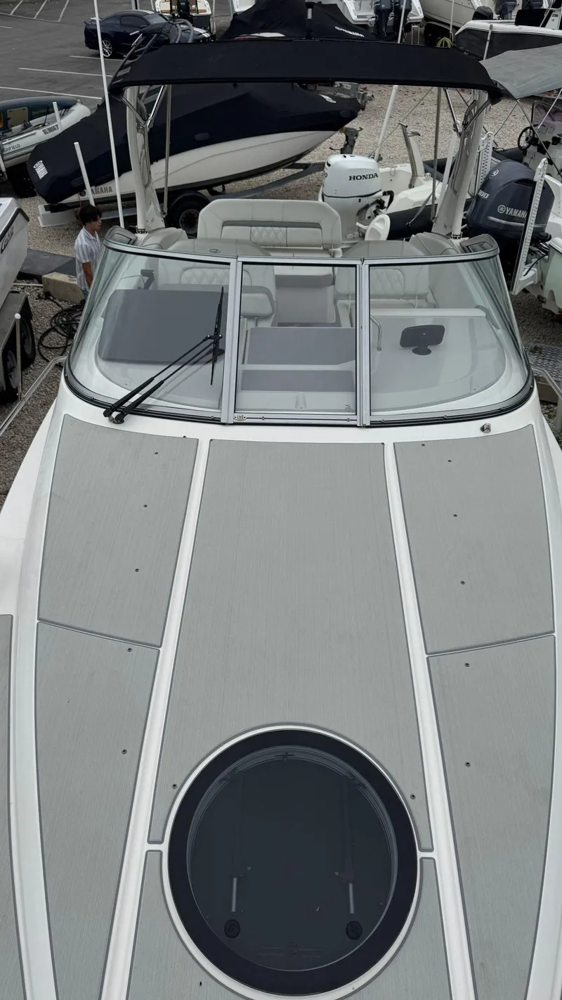 Slide: The Image of 2024 Regal 26 XO boat with sleek design and spacious deck, docked among other boats. - 7