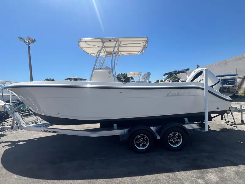 Slide: The Image of 2022 Cobia 237 Center Console boat on trailer outdoors. - 1