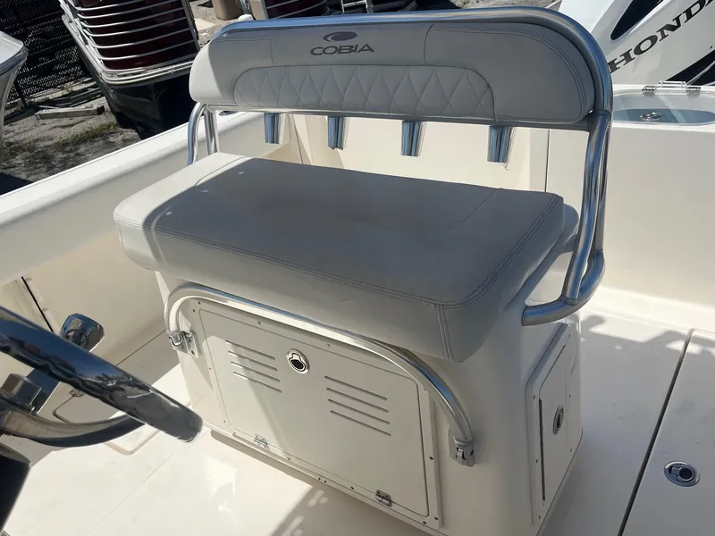 Slide: The Image of Cobia 237 Center Console 2022 seat with storage compartment. - 5