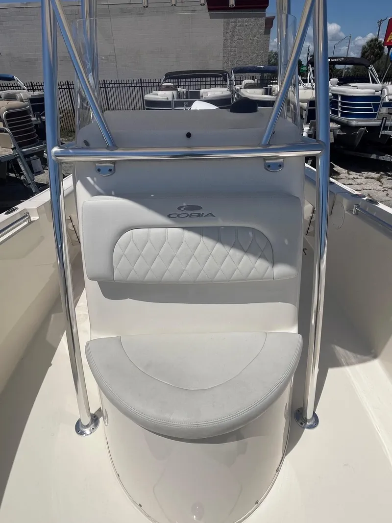 Slide: The Image of Cobia 237 Center Console 2022 with white seating and stainless steel frame. - 6