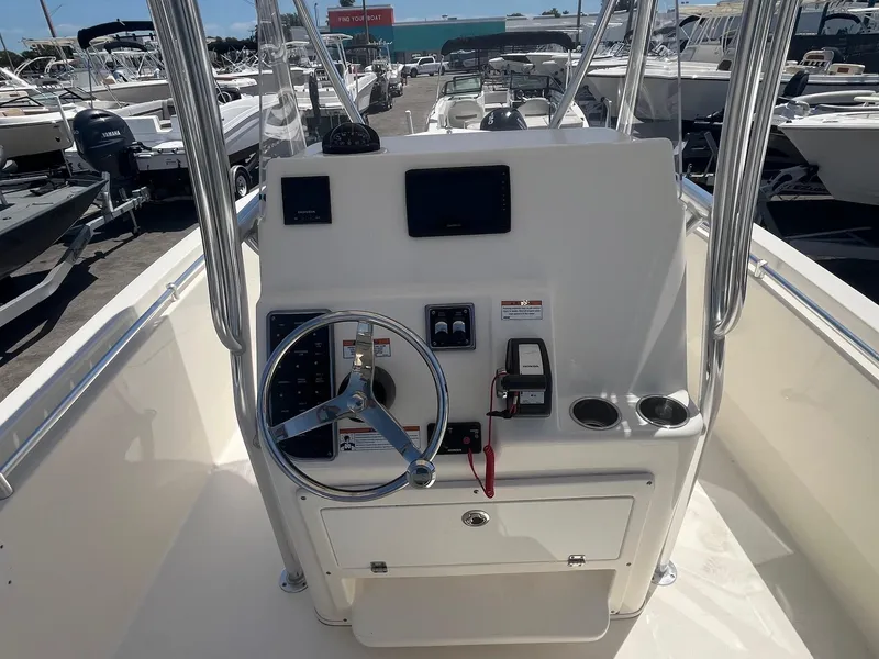Slide: The Image of Cobia 237 Center Console 2022 helm with steering wheel and instruments. - 8
