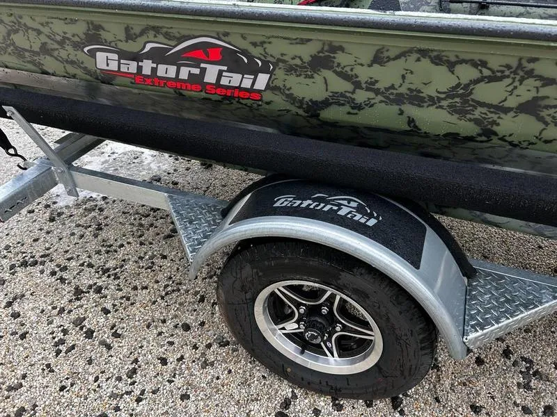 Slide: The Image of 2025 Gator Tail 1754 Extreme boat on trailer with camo design and branded logo. - 12