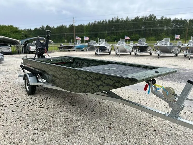 Slide: The Image of 2025 Gator Tail 1754 Extreme boat on trailer, camo design, parked outdoors. - 4