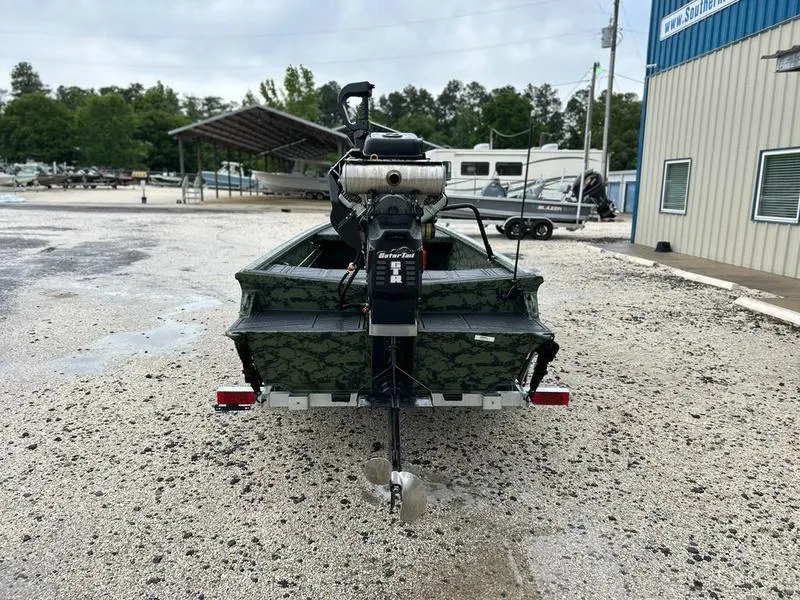 Slide: The Image of 2025 Gator Tail 1754 Extreme boat with motor, parked on gravel near a building. - 6