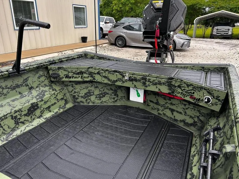 Slide: The Image of 2025 Gator Tail 1754 Extreme boat interior with camouflage design, parked outdoors. - 9