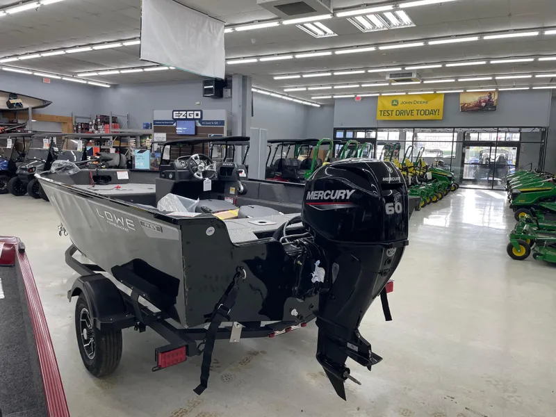 Slide: The Image of 2025 Lowe FM1675S boat with Mercury engine displayed in showroom. - 5