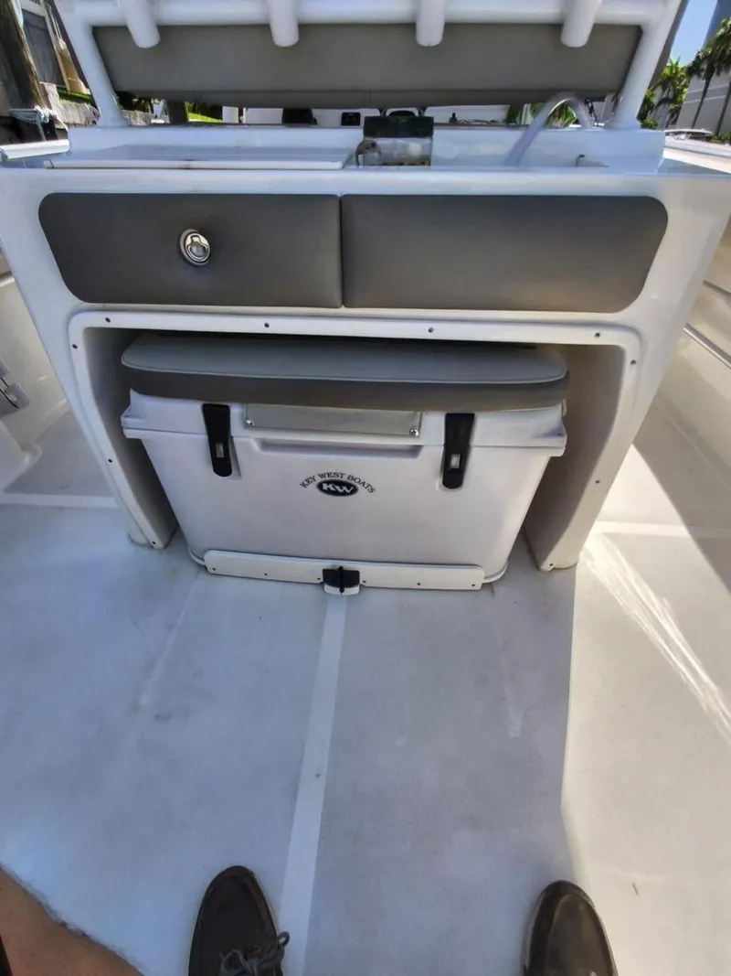 Slide: The Image of 2021 Key West 263 FS boat interior with storage compartment and cooler. - 10