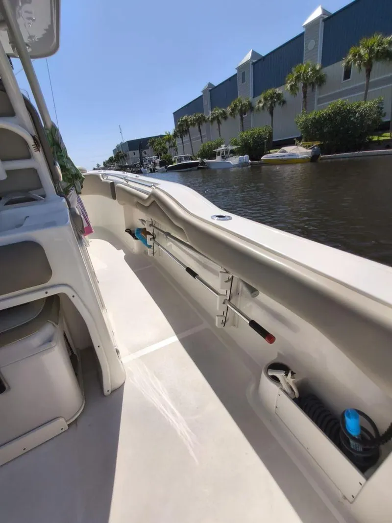 Slide: The Image of 2021 Key West 263 FS boat interior, docked by a canal with palm trees. - 12