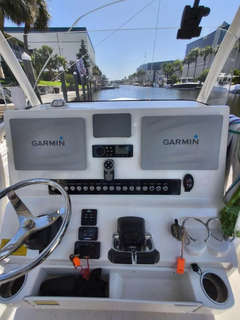 Slide: The Image of 2021 Key West 263 FS boat dashboard with Garmin navigation system, steering wheel, and controls. - 14