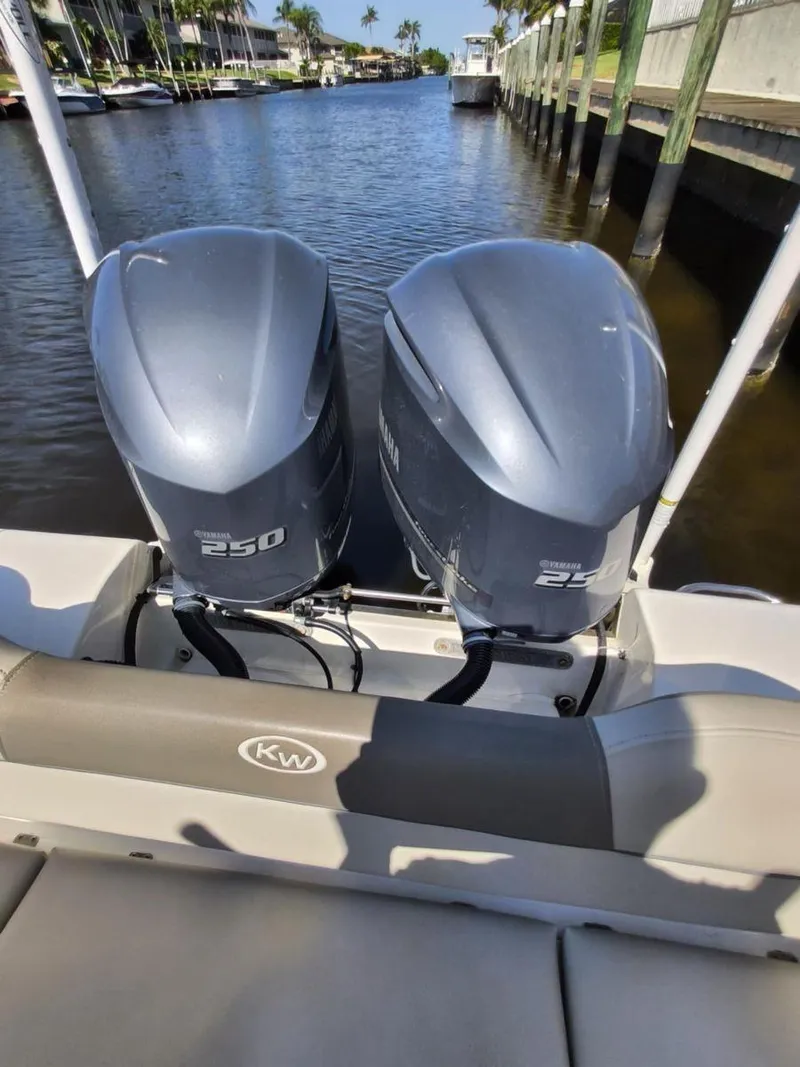 Slide: The Image of 2021 Key West 263 FS boat with twin 250 horsepower engines on a sunny waterway. - 17