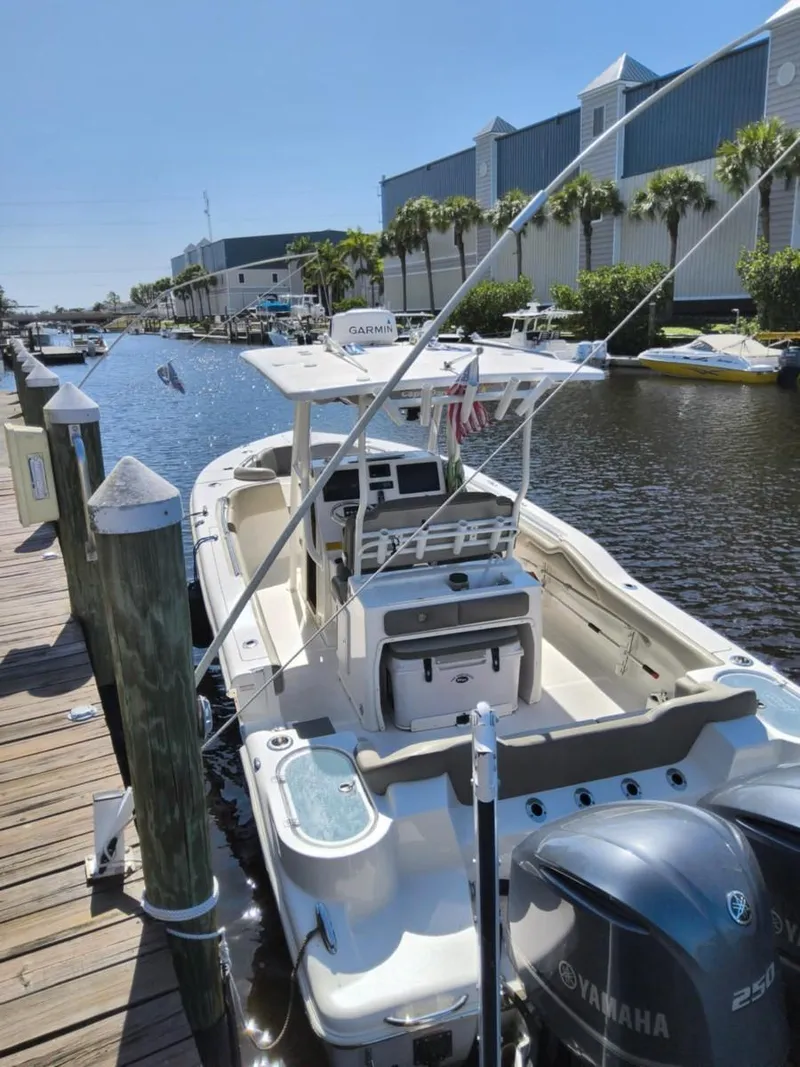 Slide: The Image of 2021 Key West 263 FS boat docked by a canal with Yamaha engines. - 4