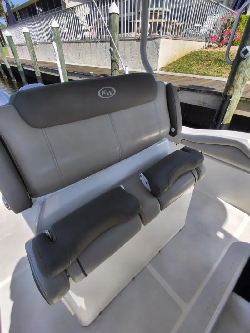 Slide: The Image of 2021 Key West 263 FS boat seating, docked, with gray cushioned seats. - 8