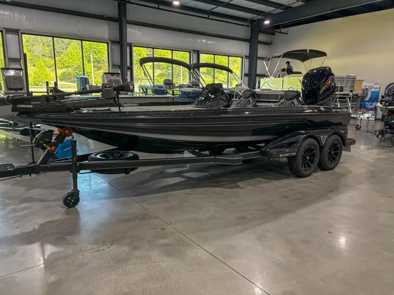 Slide: The Image of 2025 Skeeter FXR20 boat displayed indoors on a trailer. - 1