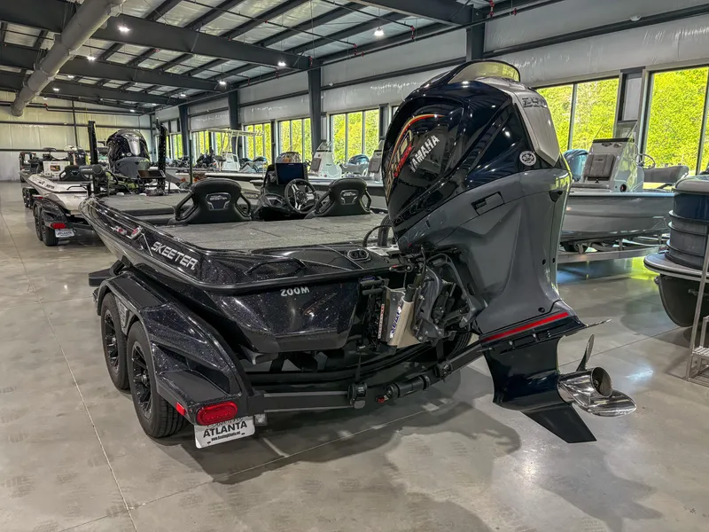 Slide: The Image of 2025 Skeeter FXR20 boat in showroom, featuring sleek design and powerful engine. - 2