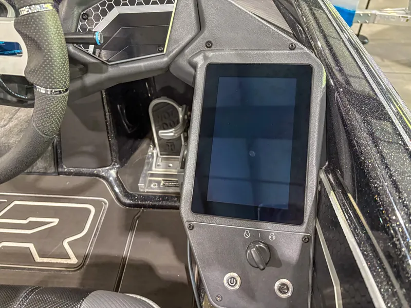Slide: The Image of 2025 Skeeter FXR20 boat dashboard with touchscreen and steering wheel detail. - 7