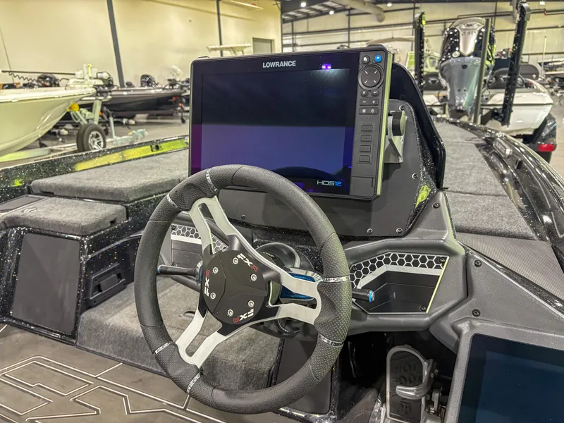 Slide: The Image of 2025 Skeeter FXR20 boat dashboard with steering wheel and Lowrance HDS display. - 8