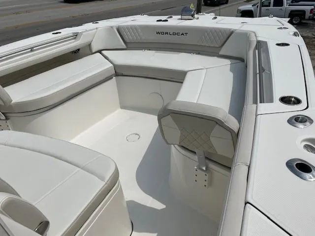 Slide: The Image of 2025 World Cat 325 CC boat interior with white seating and cup holders. - 3