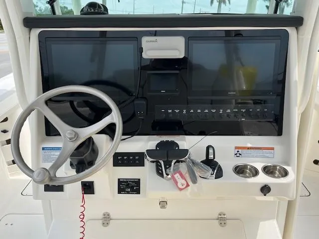 Slide: The Image of Helm of 2025 World Cat 325 CC with dual screens and steering wheel. - 4