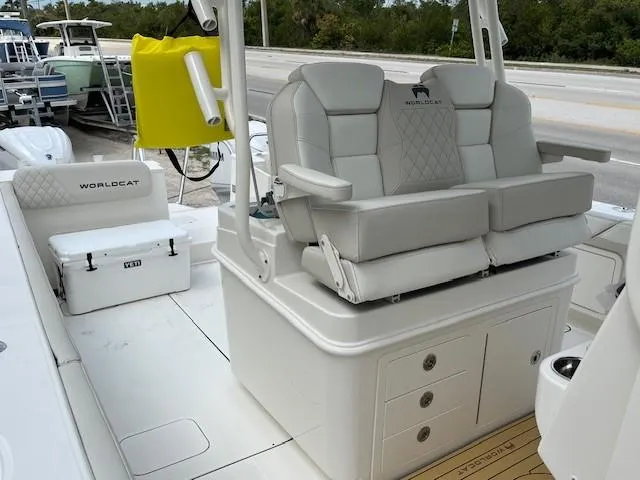 Slide: The Image of 2025 World Cat 325 CC boat interior with cushioned seating and storage compartments. - 5