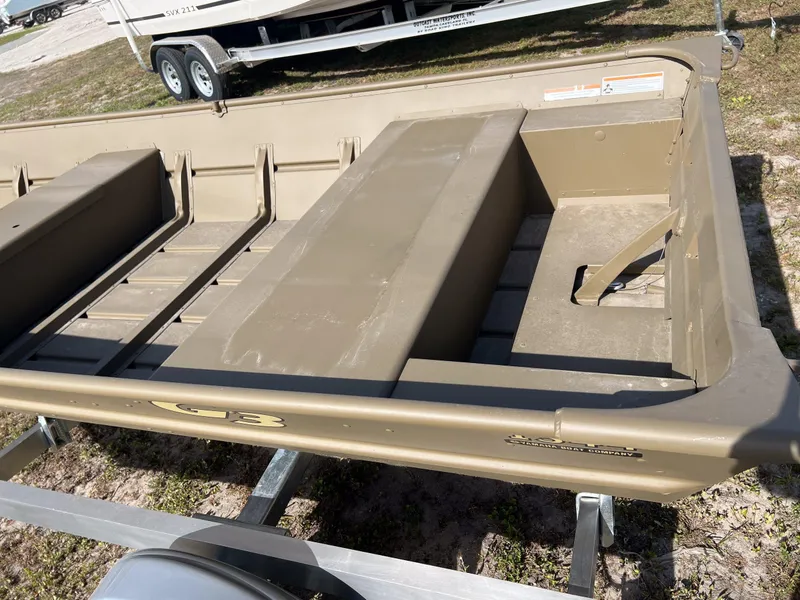 Slide: The Image of 2025 G3 1544LW boat hull on trailer, beige color, outdoor setting. - 3