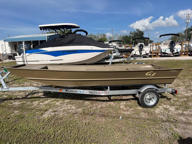Slide: The Image of 2025 G3 1544LW boat hull on trailer, parked outdoors under clear sky. - 4