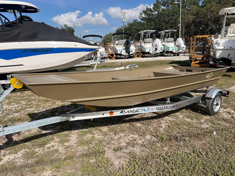 Slide: The Image of 2025 G3 1544LW boat hull on trailer, displayed outdoors with other boats. - 5