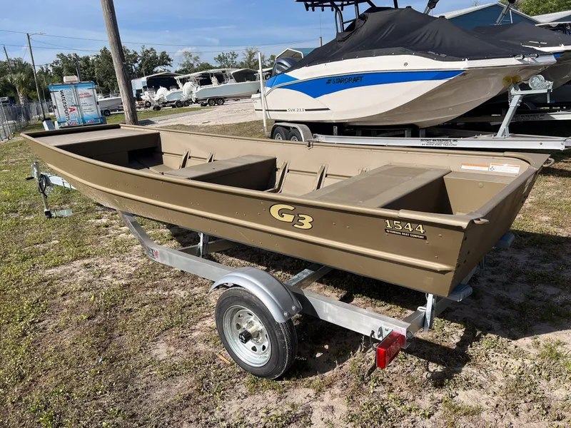 Slide: The Image of 2025 G3 1544LW hull on trailer, displayed outdoors with other boats. - 7