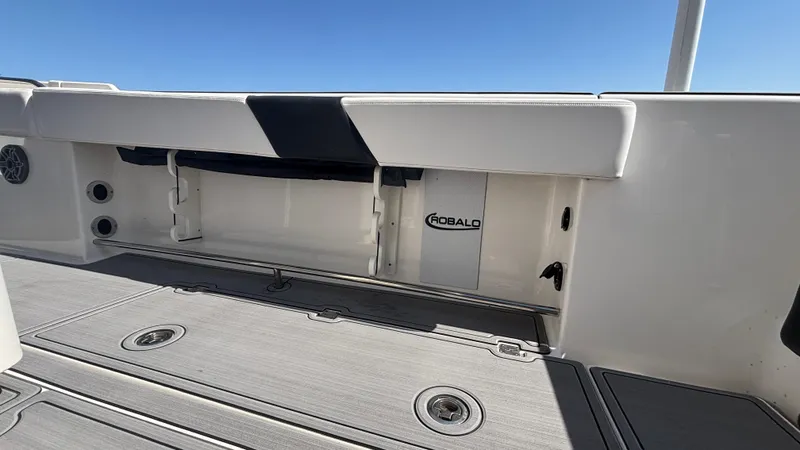 Slide: The Image of 2021 Robalo R302 CC boat interior with storage compartment and sleek design. - 16