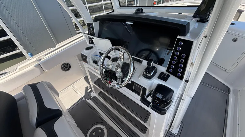 Slide: The Image of 2021 Robalo R302 CC boat cockpit with modern steering and controls. - 18