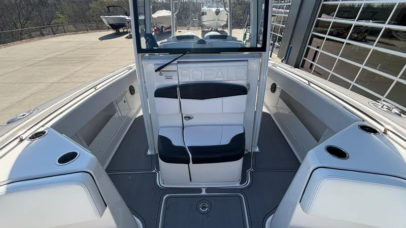 Slide: The Image of 2021 Robalo R302 CC boat interior with seating and cup holders. - 23