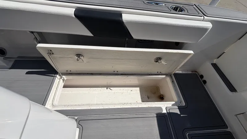 Slide: The Image of Open storage compartment on 2021 Robalo R302 CC boat deck. - 32
