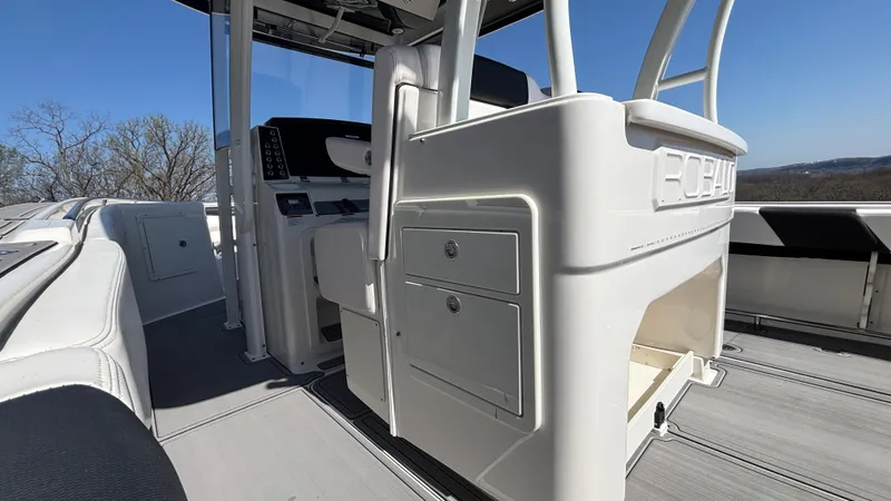 Slide: The Image of 2021 Robalo R302 CC boat interior with helm station and storage compartments. - 34