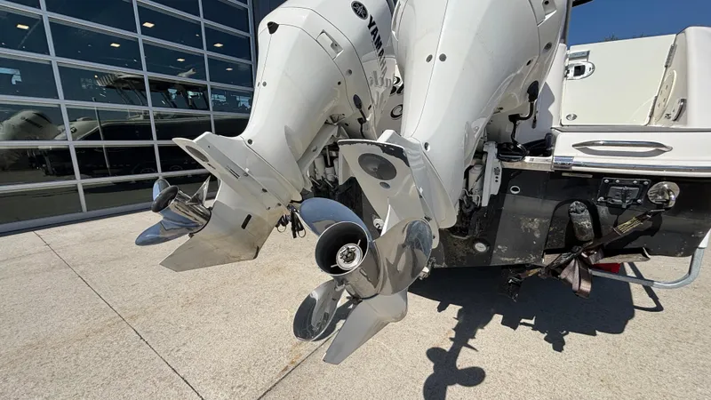 Slide: The Image of 2021 Robalo R302 CC boat with dual outboard engines, displayed outdoors. - 39