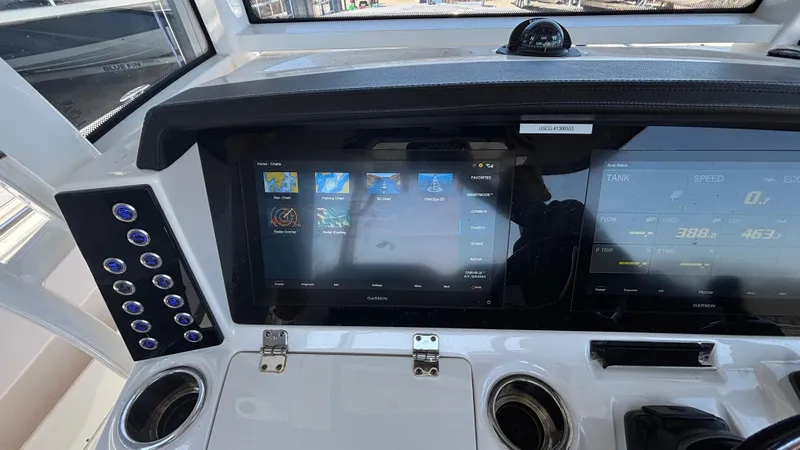 Slide: The Image of 2021 Robalo R302 CC dashboard with touchscreen controls and cup holders. - 43