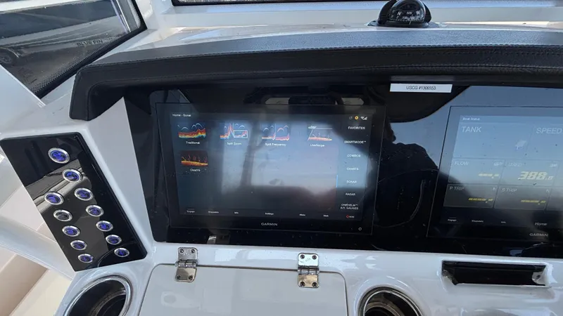 Slide: The Image of Dashboard of 2021 Robalo R302 CC boat with touchscreen controls and navigation display. - 44