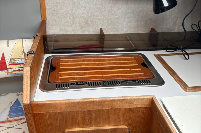 Slide: The Image of 1989 O'Day 272 yacht interior with wooden countertop and cutting board. - 13